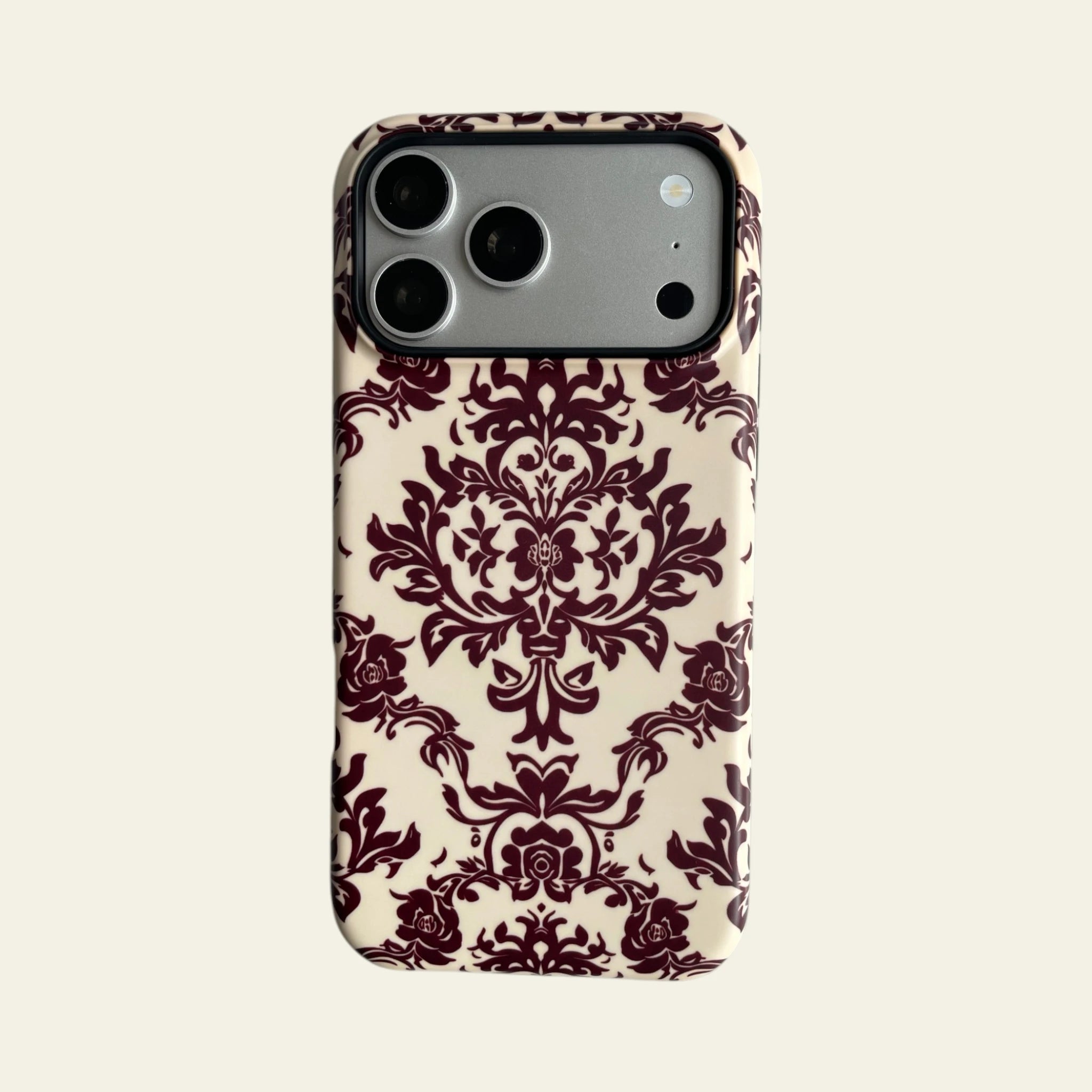 Full front view of Mewvia Burgundy Damask case for iPhone 17 Pro Max, showcasing the intricate symmetrical pattern and MagSafe integration.