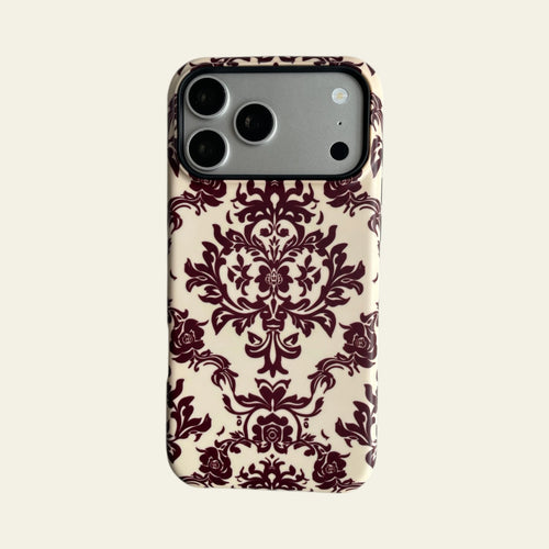 Full front view of Mewvia Burgundy Damask case for iPhone 17 Pro Max, showcasing the intricate symmetrical pattern and MagSafe integration.