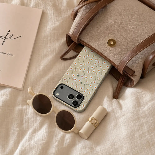 Butter Yellow Daisy matte case on iPhone 17 Pro Max, placed next to a ceramic cup of coffee on a minimalist white stone table with soft sunlight.