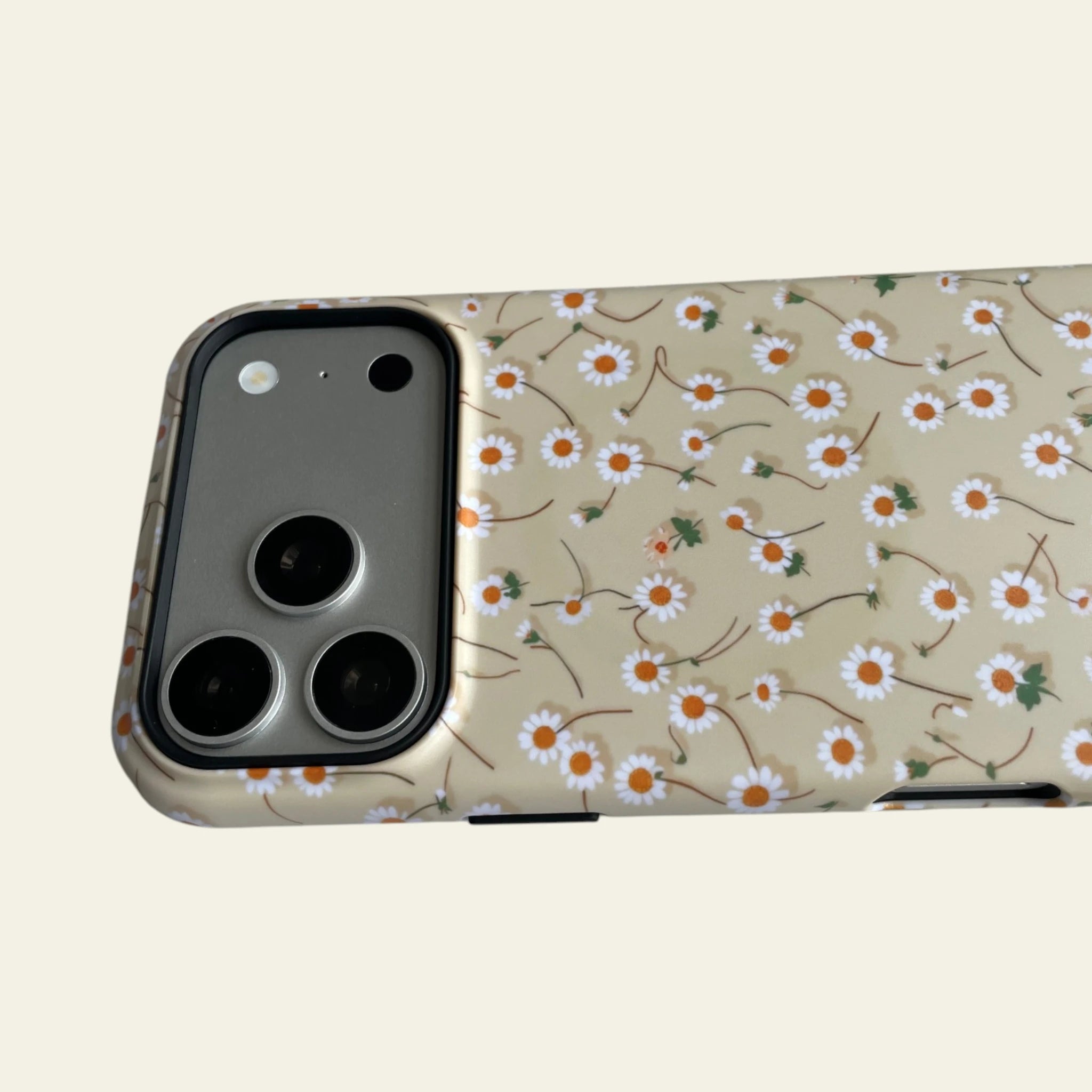 Close-up of the premium matte finish on the Butter Yellow Daisy case, highlighting the anti-fingerprint and anti-fade floral print.