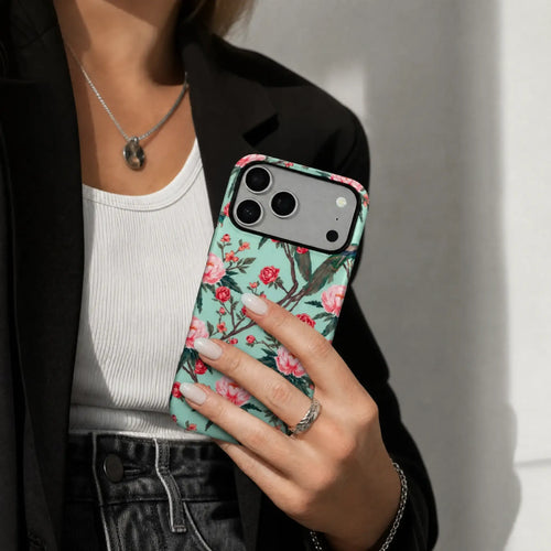 Chinoiserie Peacock and Peony matte case on iPhone 17 Pro Max, styled with a minimalist ceramic vase and soft afternoon shadows.