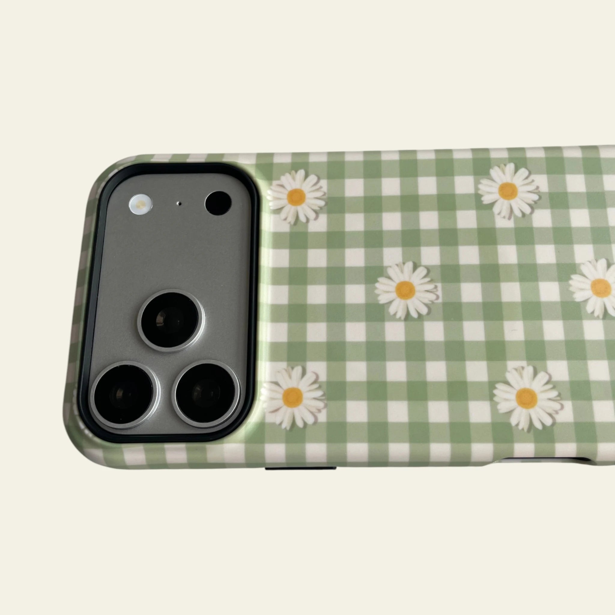Close-up of the premium matte finish and embossed Mewvia logo on the Mint Gingham Daisy case, highlighting the anti-fingerprint and anti-fade surface.