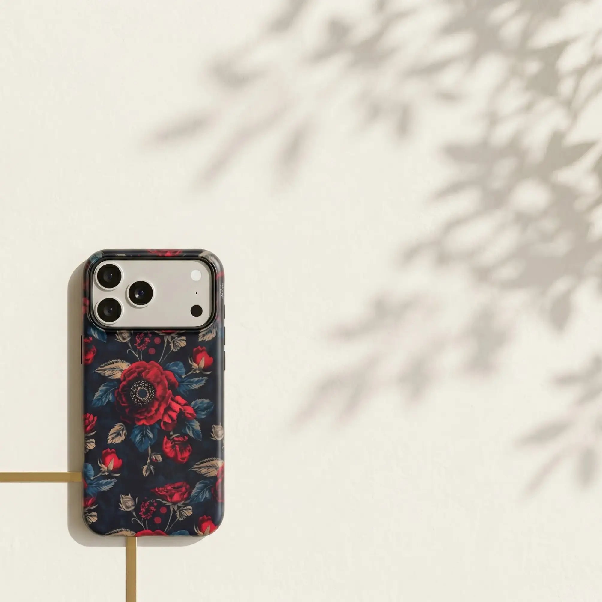 Mewvia Moody Dark Botanical floral case for iPhone 17 Pro Max in a lifestyle setting.