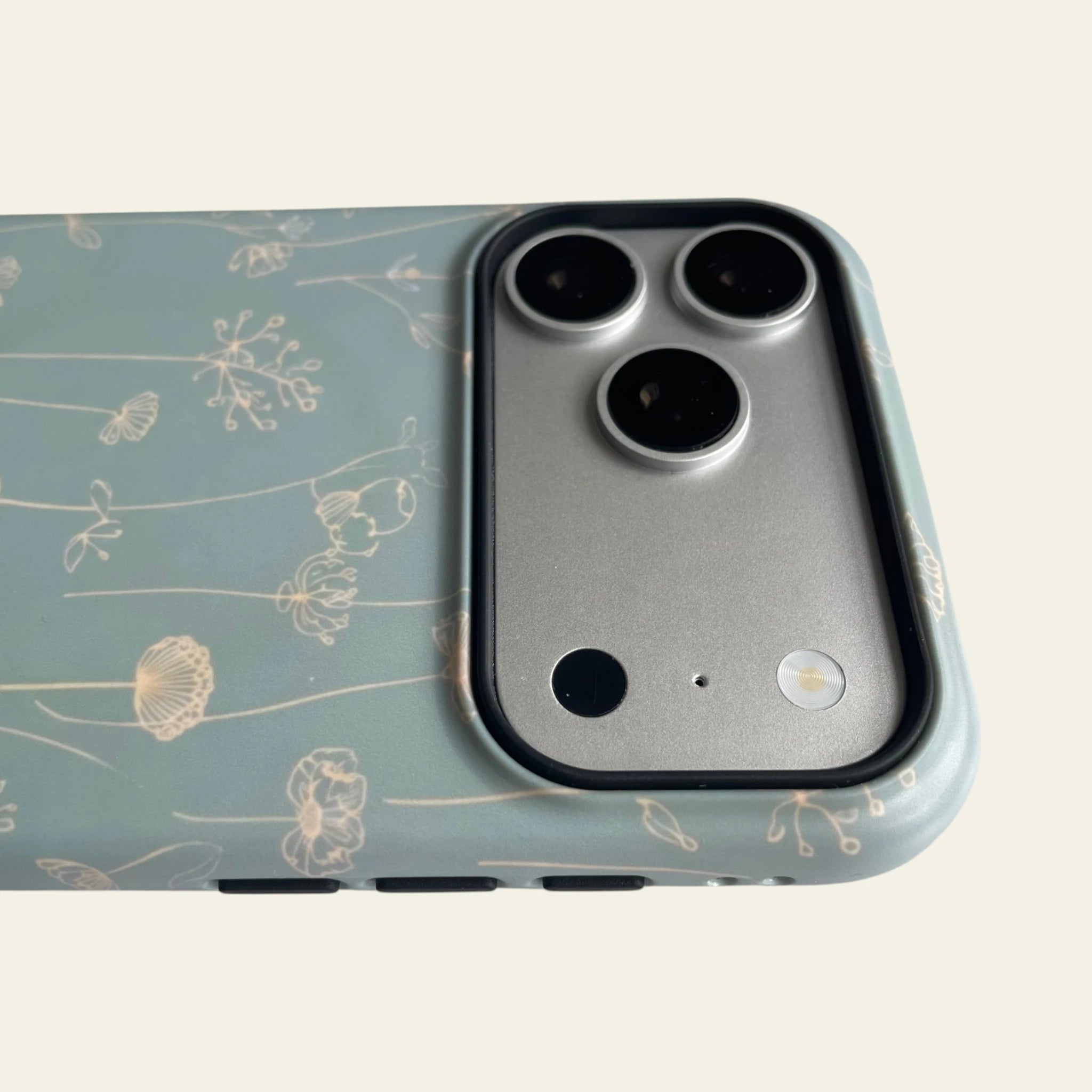 MagSafe compatible feature view of the Mewvia Sage Green line art wildflower iPhone 17 Pro Max case.