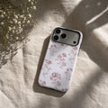 Vintage Pink Rose matte case on iPhone 17 Pro Max, styled with a linen napkin and a single dried rose on a minimalist stone surface.