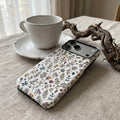 Vintage Wildflower matte case on iPhone 17 Pro Max, styled with botanical elements in a soft-lit, minimalist environment.